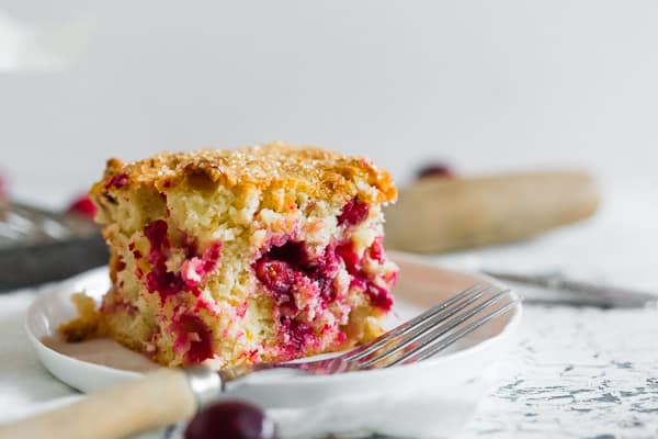 Vanilla Cranberry Buttermilk Cake sliced to show cranberries.