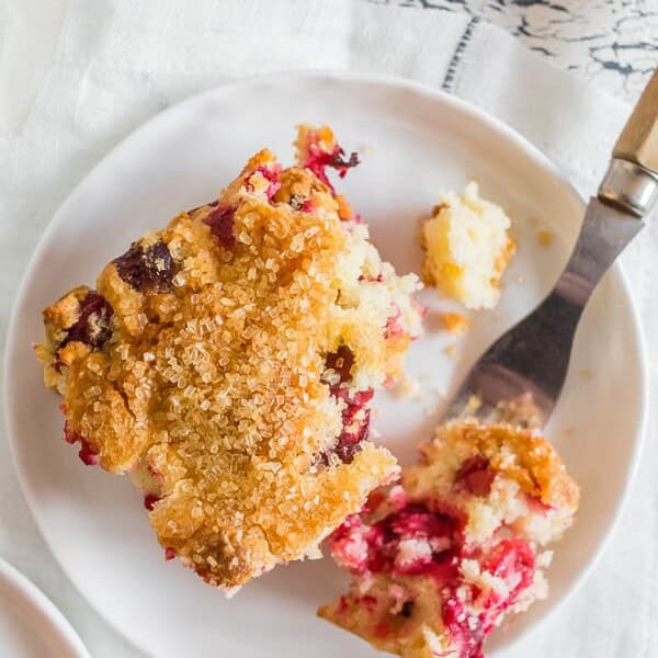 This vanilla cranberry buttermilk cake is the perfect Christmas cake. Full of fresh cranberries, vanilla beans, orange zest and a sprinkle of turbinado sugar on top for an extra special sparkly surprise. You'll love how easy it is to make this tasty breakfast or dessert treat!