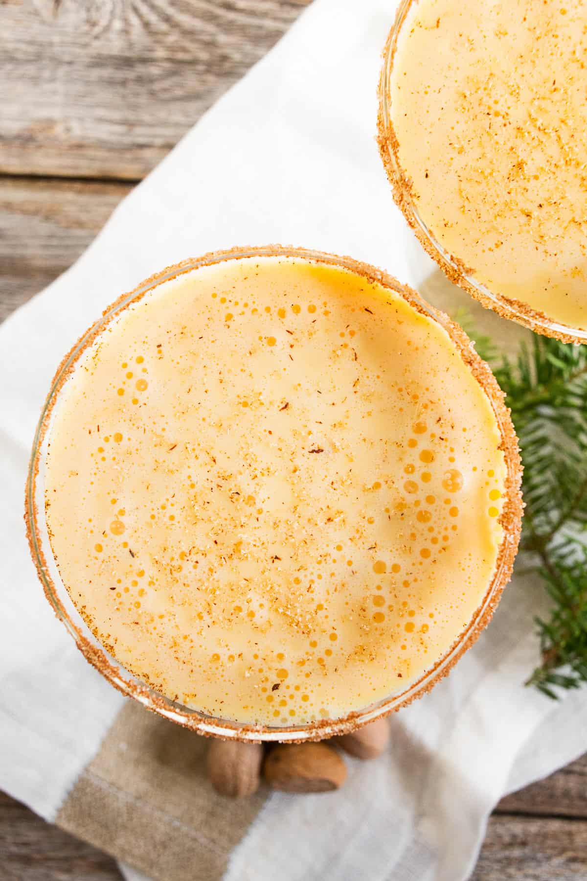 eggnog martini in a glass with cinnamon sugar rim
