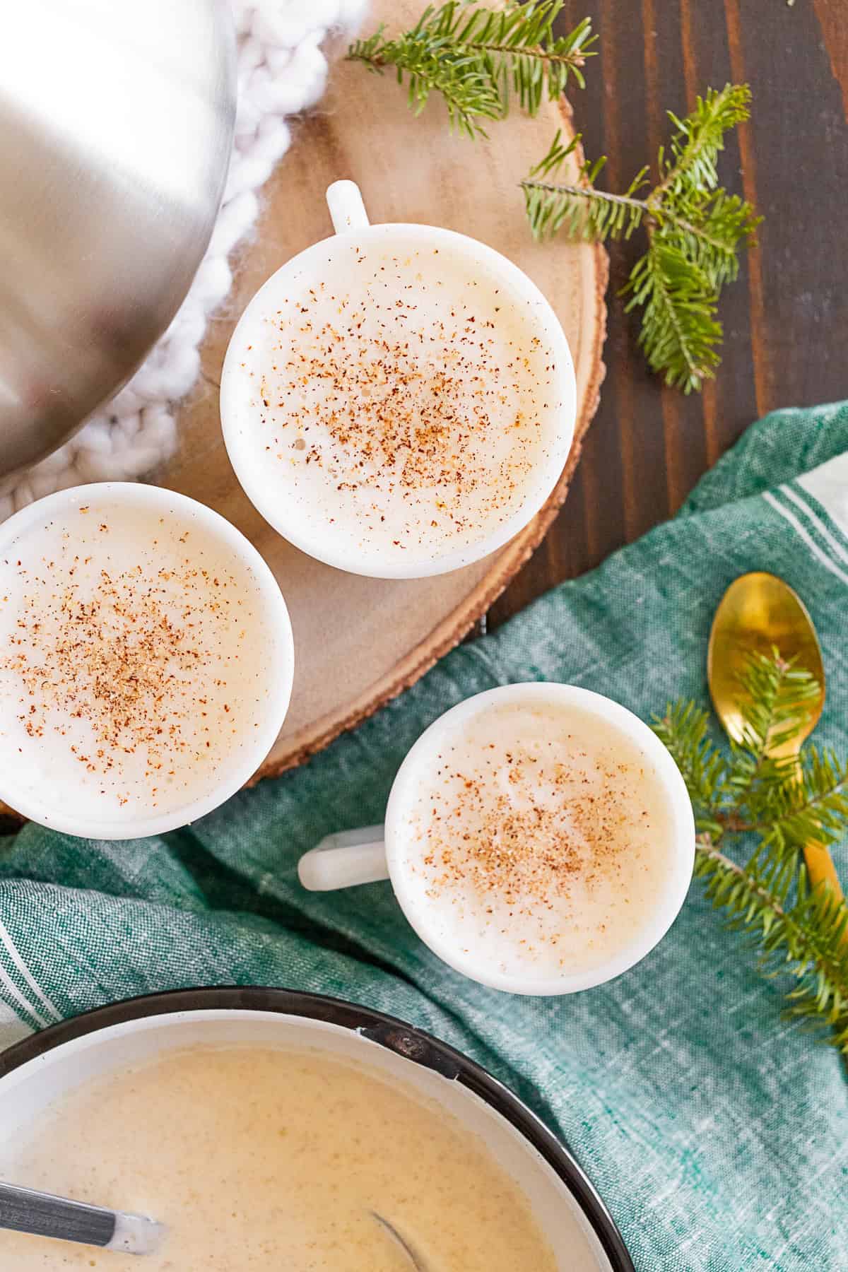 Tom and Jerry Cocktail Recipe in mugs with a bowl of batter.
