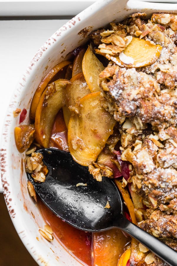 This vanilla bean persimmon crisp is the perfect holiday dessert. It's made with thinly sliced seasonal persimmons, chopped fresh cranberries, vanilla bean paste and topped with a homemade vanilla oat and almond mixture. You'll love this simple winter dessert!
