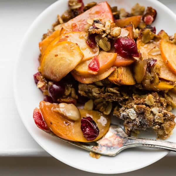 This vanilla persimmon crisp is the perfect holiday dessert. It's made with thinly sliced seasonal persimmons, chopped fresh cranberries, vanilla bean paste and topped with a homemade vanilla oat and almond mixture. You'll love this simple winter dessert!
