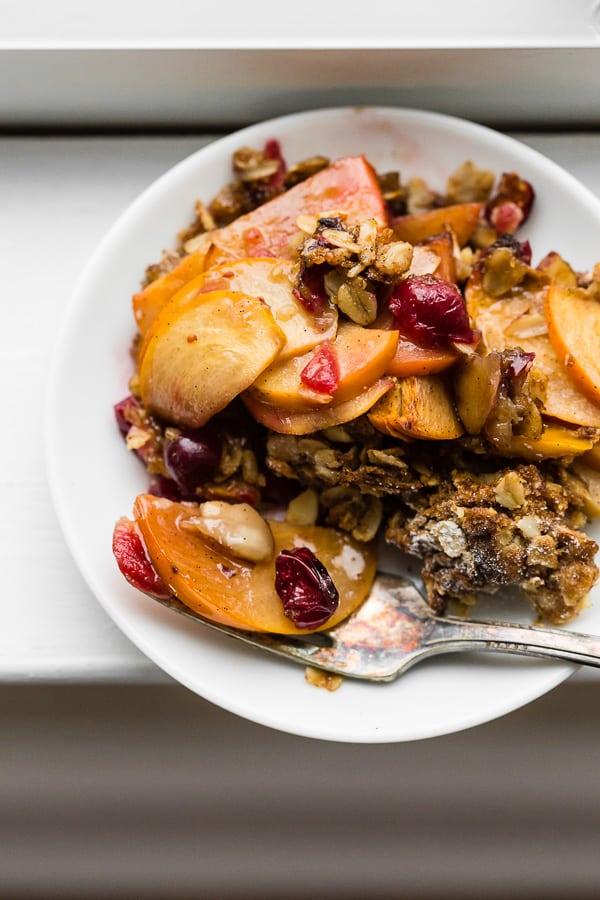 This vanilla bean persimmon crisp is the perfect holiday dessert. It's made with thinly sliced seasonal persimmons, chopped fresh cranberries, vanilla bean paste and topped with a homemade vanilla oat and almond mixture. You'll love this simple winter dessert!