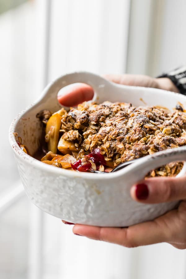 This vanilla bean persimmon crisp is the perfect holiday dessert. It's made with thinly sliced seasonal persimmons, chopped fresh cranberries, vanilla bean paste and topped with a homemade vanilla oat and almond mixture. You'll love this simple winter dessert!