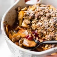 This vanilla persimmon crisp is the perfect holiday dessert. It's made with thinly sliced seasonal persimmons, chopped fresh cranberries, vanilla bean paste and topped with a homemade vanilla oat and almond mixture. You'll love this simple winter dessert!