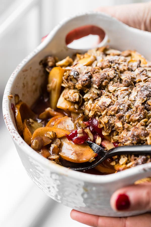 This vanilla bean persimmon crisp is the perfect holiday dessert. It's made with thinly sliced seasonal persimmons, chopped fresh cranberries, vanilla bean paste and topped with a homemade vanilla oat and almond mixture. You'll love this simple winter dessert!