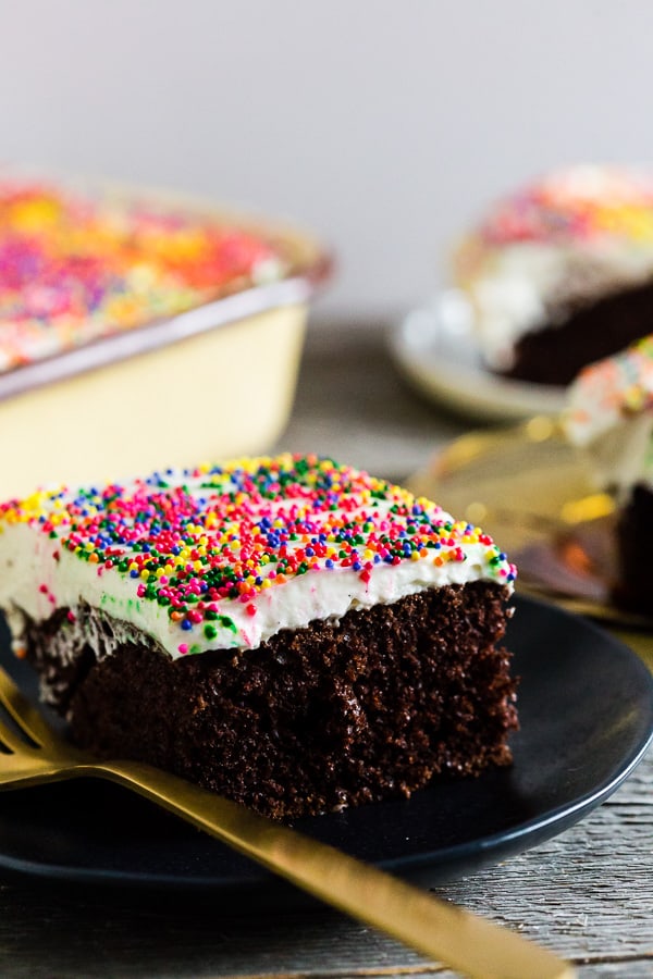 fluffy cream cheese frosting on dark chocolate cake