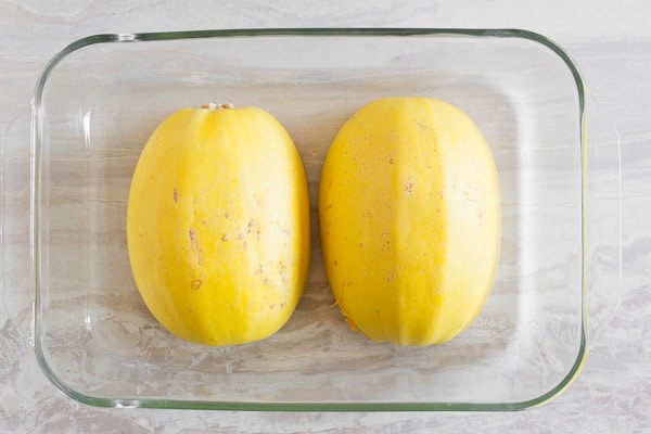 spaghetti squash halves in a glass dish