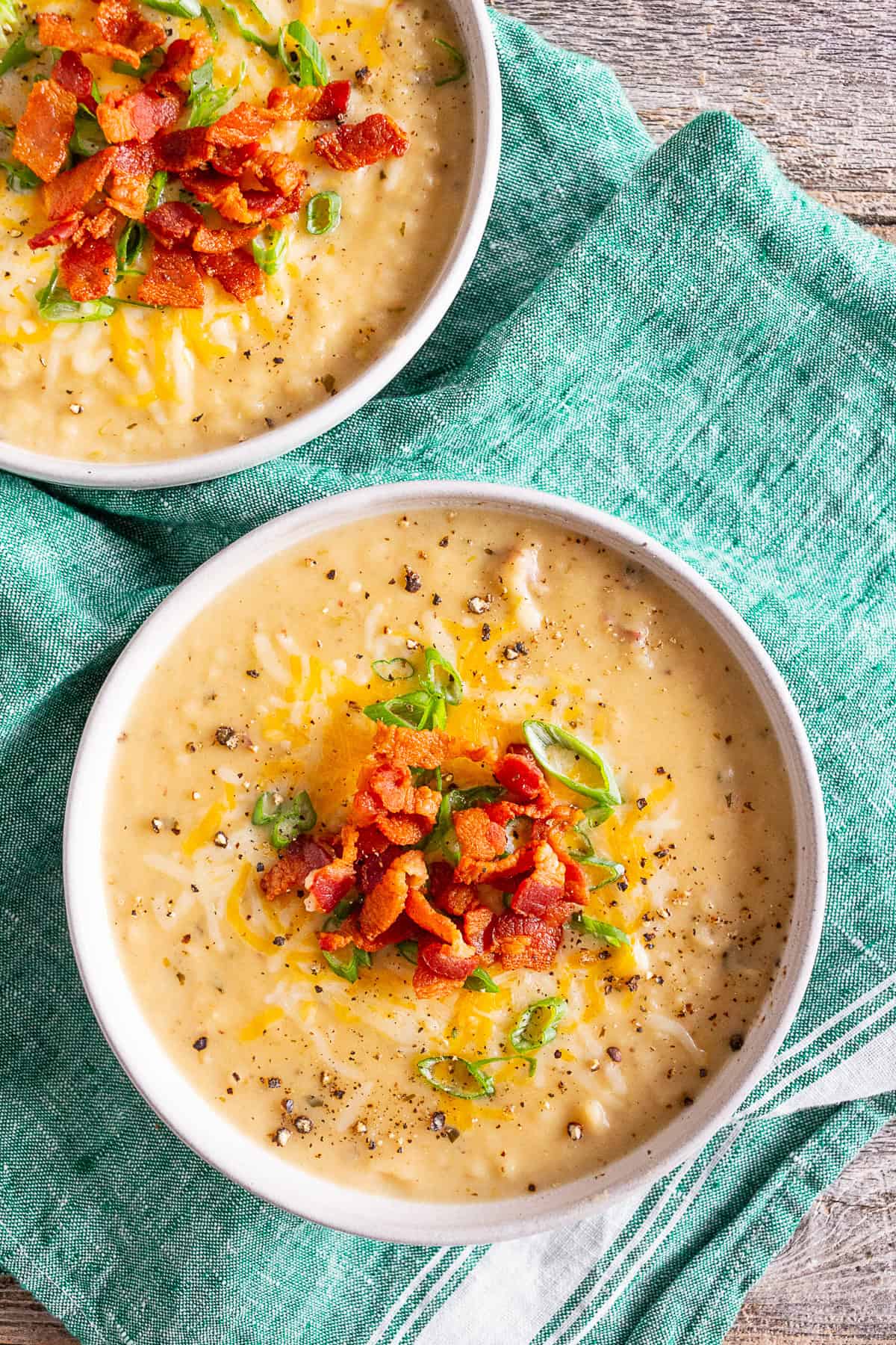 Loaded Baked Potato Soup topping with shredded cheese.