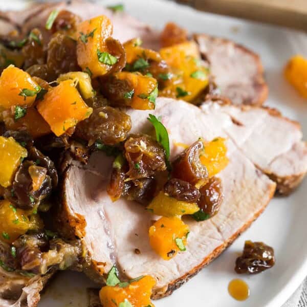 This roast pork loin with dried fruit compote is an easy and flavorful dinner recipe that your whole family will love. Serve with rice, buttered noodles or even mashed potatoes. Juicy roast pork served with a homemade compote made out of golden raisins, dried apricots, dates, orange juice and just a touch of cilantro. So good!