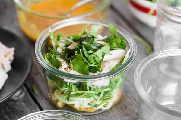 Fresh herbs in glass jar.