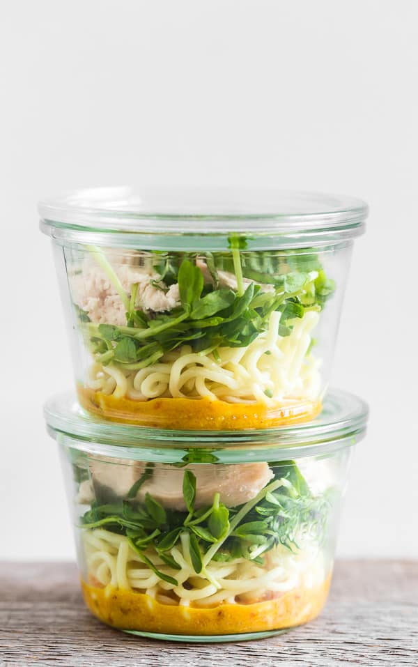 Glass jars filled with ingredients to make homemade cup of noodles.