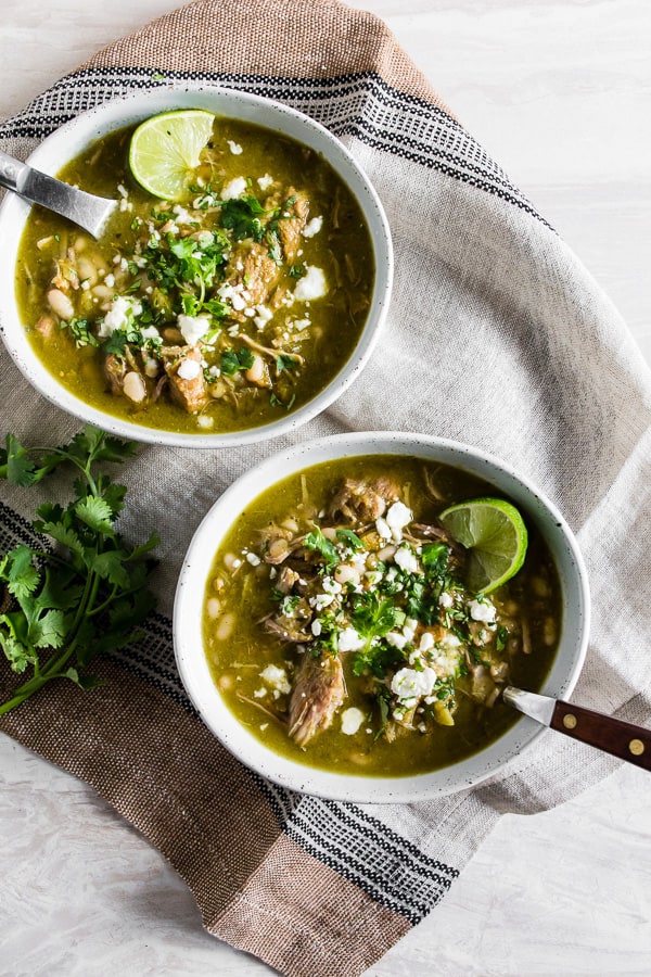 Instant Pot Pork Chili Verde in a bowl topped with cilantro and cotija cheese.
