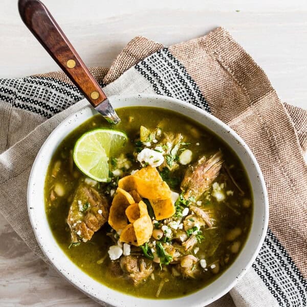 This Instant Pot pork chili verde is made with cilantro, tomatillos, garlic, pork and soft white beans. Great when topped with cotija cheese and crispy corn chips!