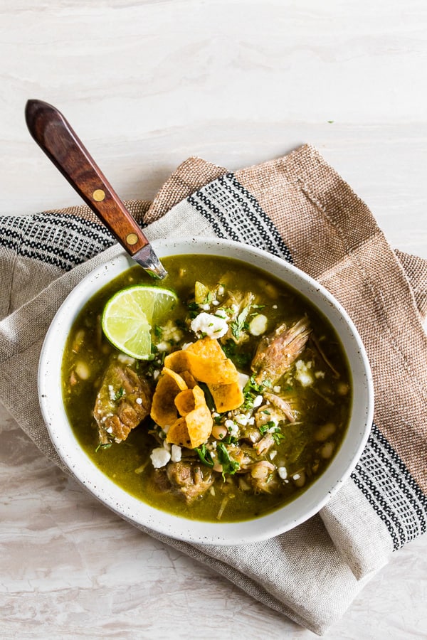 Instant Pot Pork Chili Verde in a bowl with a spoon.