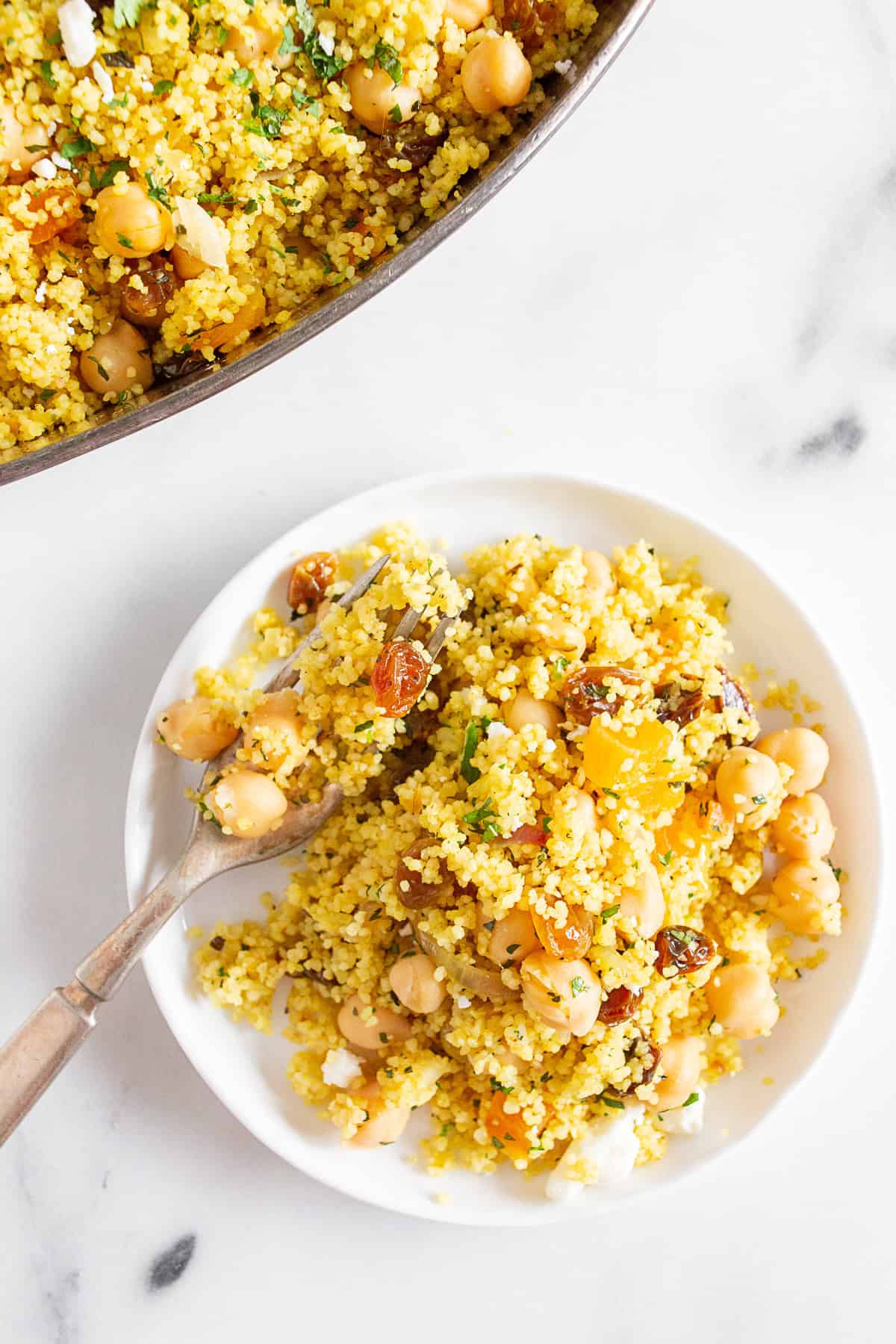 Moroccan Couscous on a plate with a fork. 