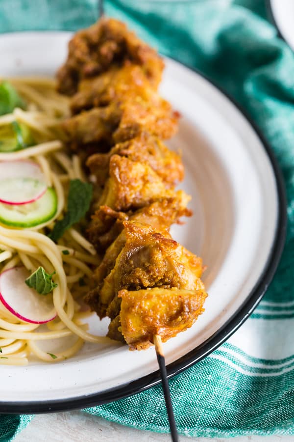 Chicken Satay Noodles served with fresh herbs. 