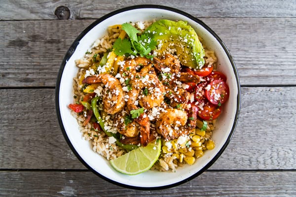 Chipotle Shrimp Fajita Bowls drizzled with yogurt sauce. 