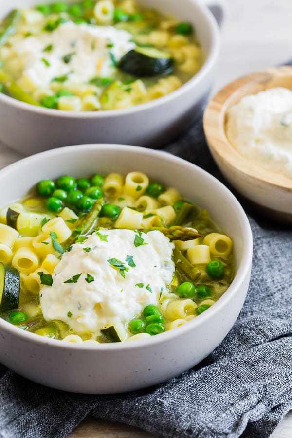 Spring Minestrone Soup with Lemon Whipped Ricotta topped with fresh herbs. 