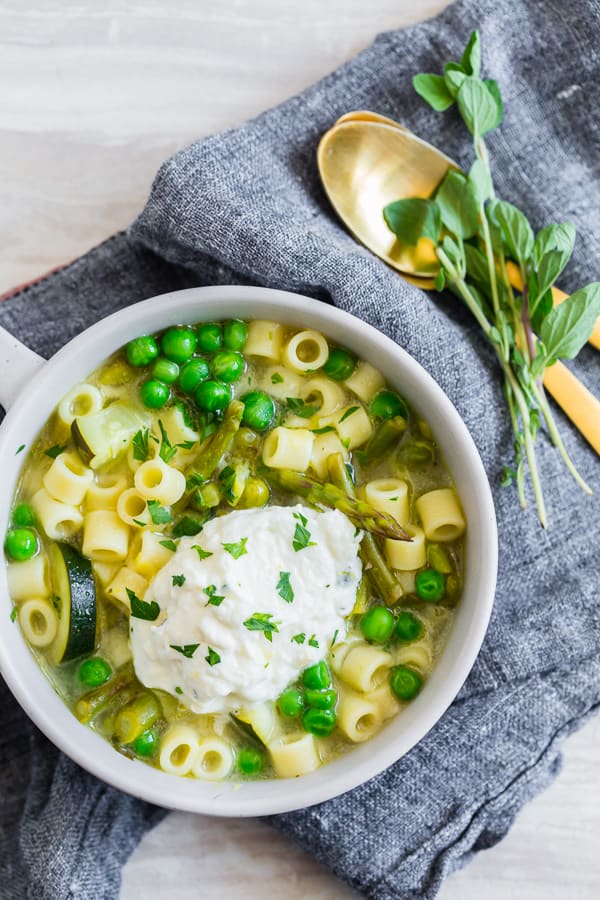 Spring Minestrone Soup with Lemon Whipped Ricotta in a bowl. 