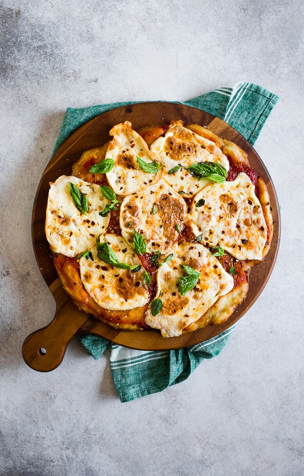This smoked mozzarella pizza is topped with a light layer of marinara sauce, freshly smoked mozzarella cheese, fresh herbs and a sprinkle of grated Parmesan. It's packed full of flavor and cooks in just about 20 minutes. 