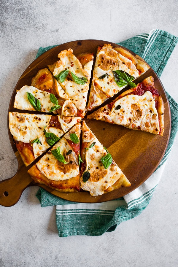 This smoked mozzarella pizza is topped with a light layer of marinara sauce, freshly smoked mozzarella cheese, fresh herbs and a sprinkle of grated Parmesan. It's packed full of flavor and cooks in just about 20 minutes. 
