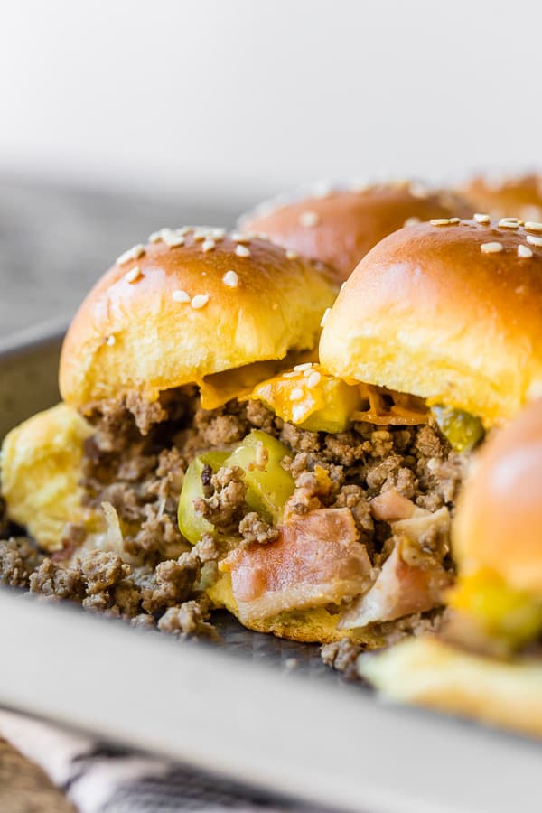 showing the inside of baked bacon cheeseburger sliders