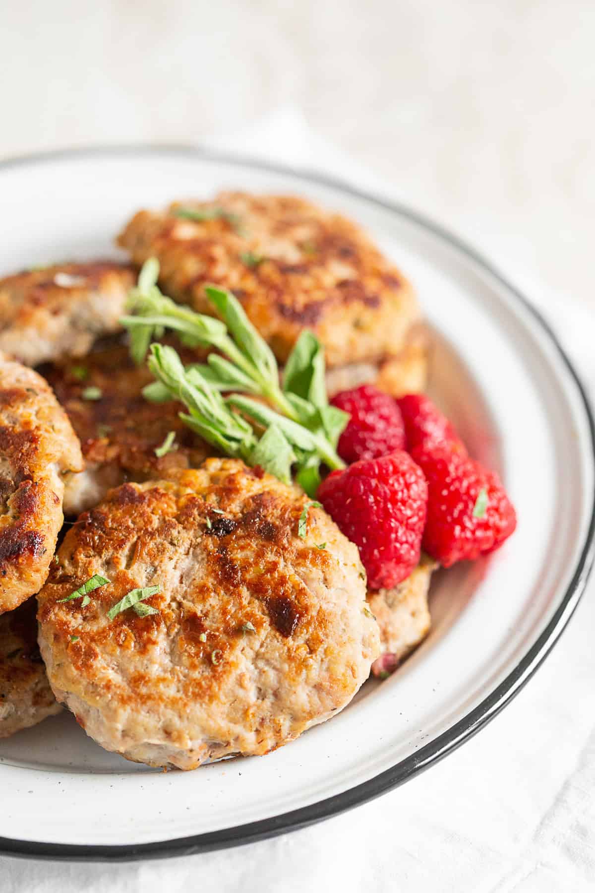 Homemade Chicken Sausage Patties served with raspberries. 