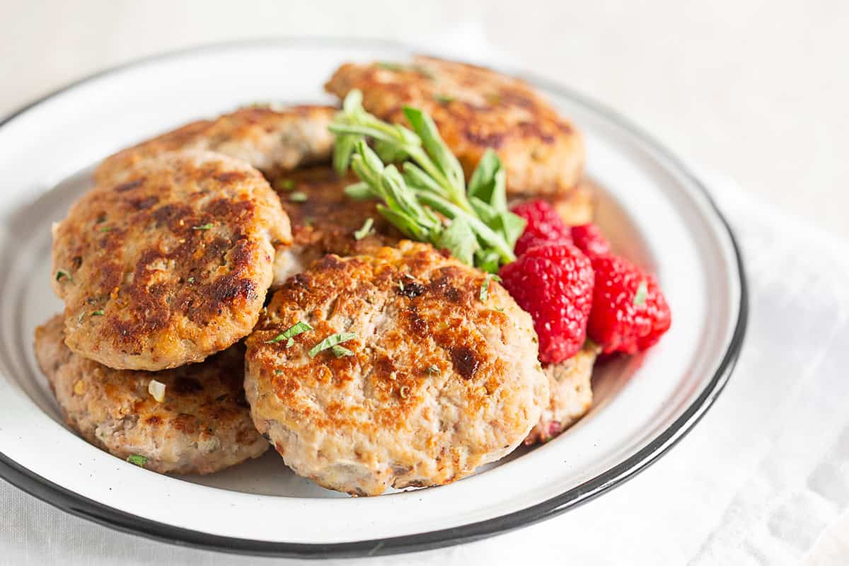 Homemade Chicken Sausage Patties on a white plate. 
