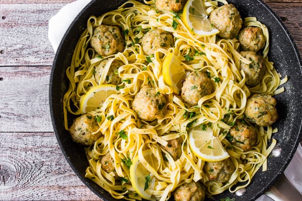 Baked Chicken Francese Meatballs in a skillet with pasta and sauce