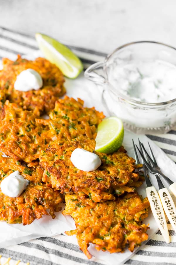 easy carrot fritters topped with greek yogurt sauce