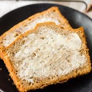 sliced sourdough discard banana bread with butter