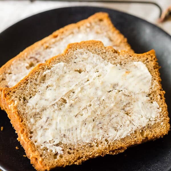 sliced sourdough discard banana bread with butter