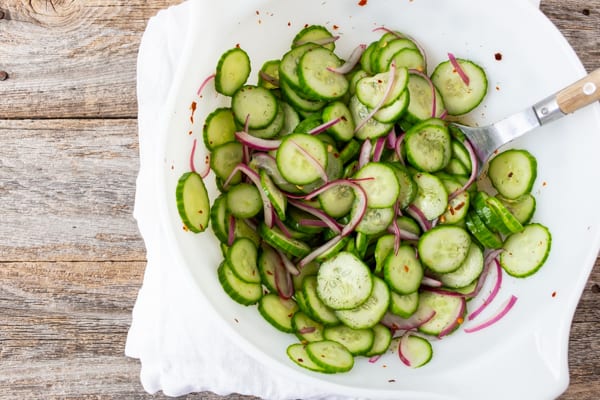 large white bowl filled with sliced cucumber salad