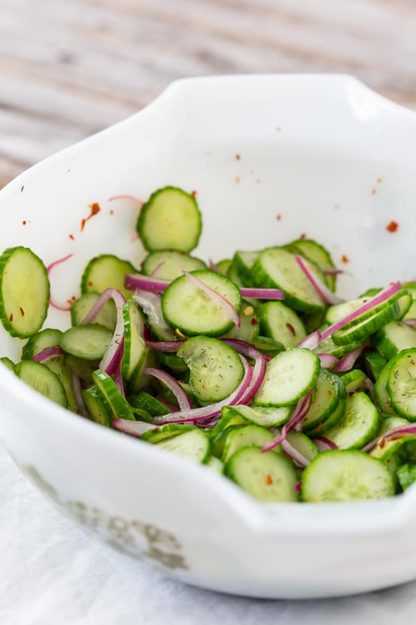cucumber salad in a white bowl