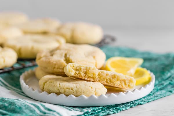 vanilla bean lemon sugar cookie broken in half on a plate