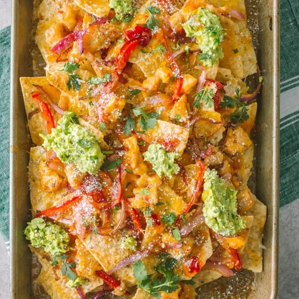 sweet chili chicken nachos on a small sheetpan