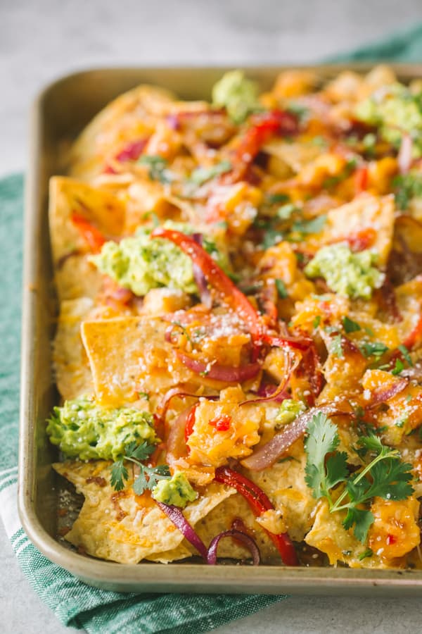 Thai sweet chili chicken nachos topped with avocado and cilantro.