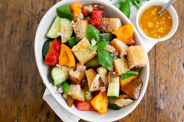 grilled sourdough panzanella salad with tomatoes in a bowl