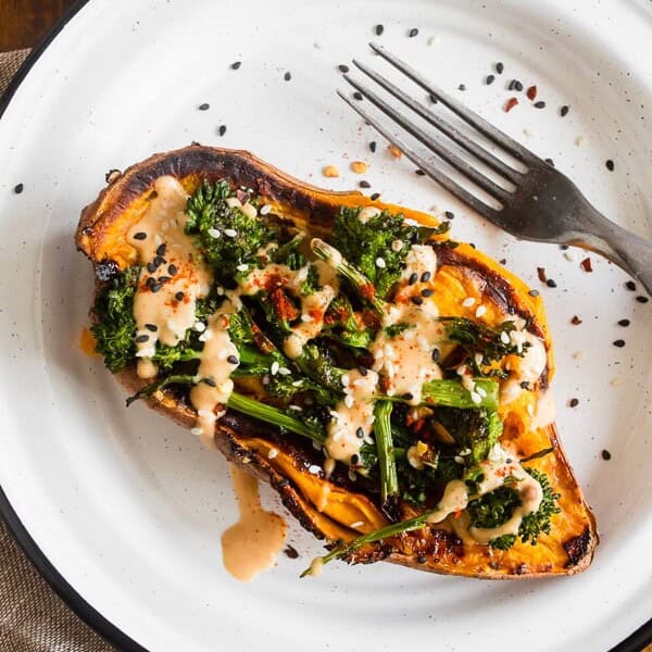 broccoli rabe and hummus stuffed overhead shot of sweet potatoes on a plate