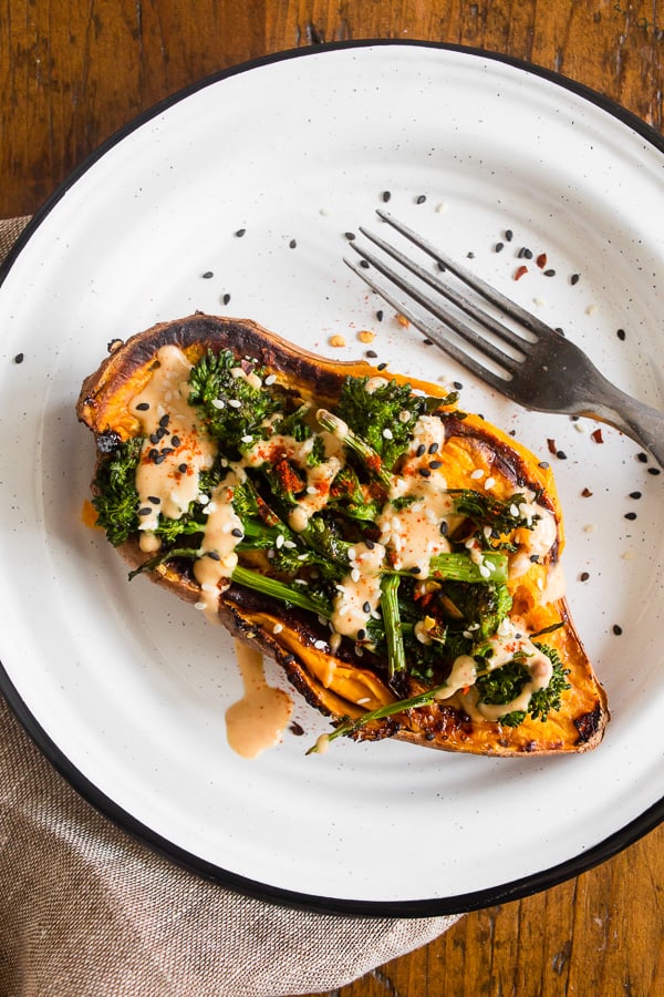 broccoli rabe and hummus stuffed overhead shot of sweet potatoes on a plate