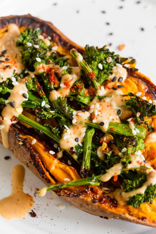close up shot of broccoli rabe and hummus stuffed sweet potatoes on a plate