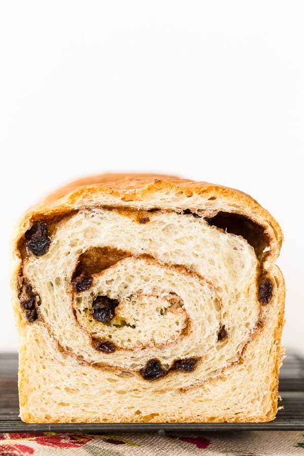 cinnamon raisin sourdough bread cut in half with the swirl showing