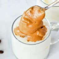 adding the pumpkin spice whipped coffee to a mug