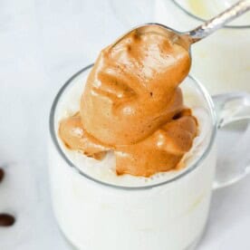 adding the pumpkin spice whipped coffee to a mug