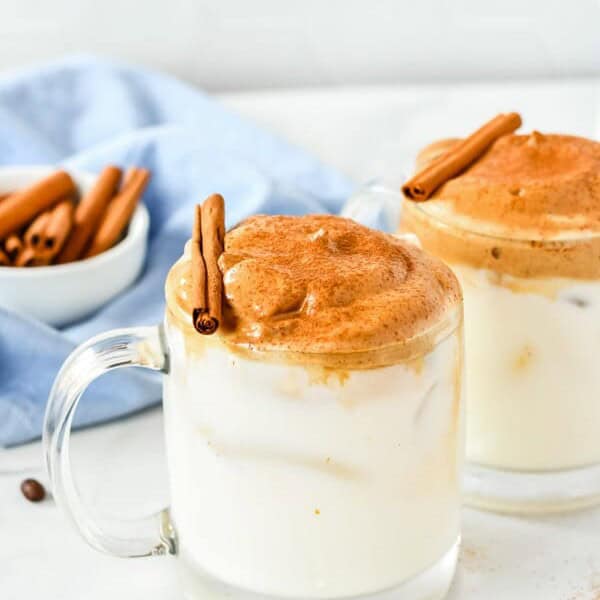 two mugs of pumpkin spice whipped coffee