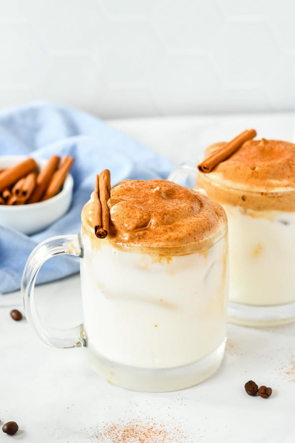 two mugs of pumpkin spice whipped coffee