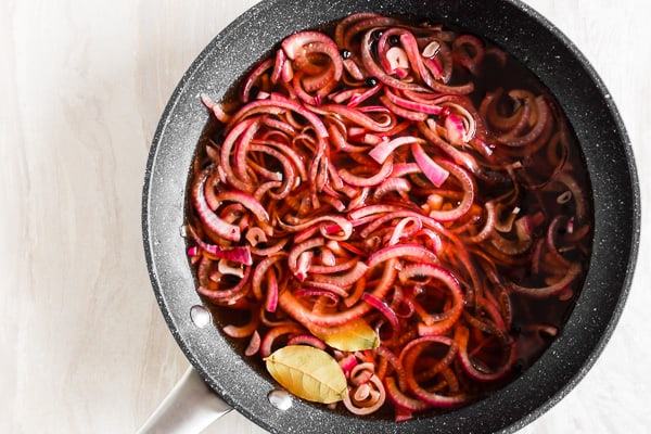 overhead shot of quick and easy pickled red onions in a pan