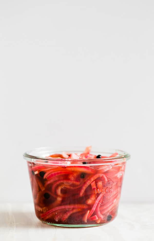side shot of quick and easy pickled red onions in a jar