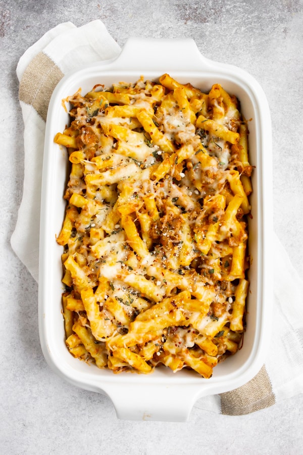 Creamy Pumpkin Baked Ziti in a white casserole dish